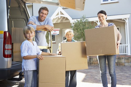Professional man and van loading boxes at a South London property